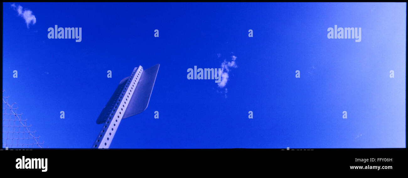 Low Angle View Of Sign Board Against Blue Sky Stock Photo