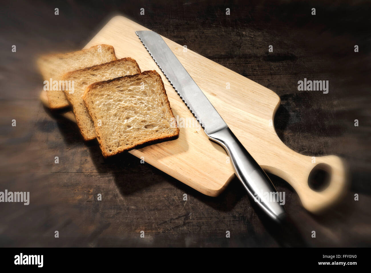 Kitchen things , bread with bread knife on wooden cutting board Stock Photo