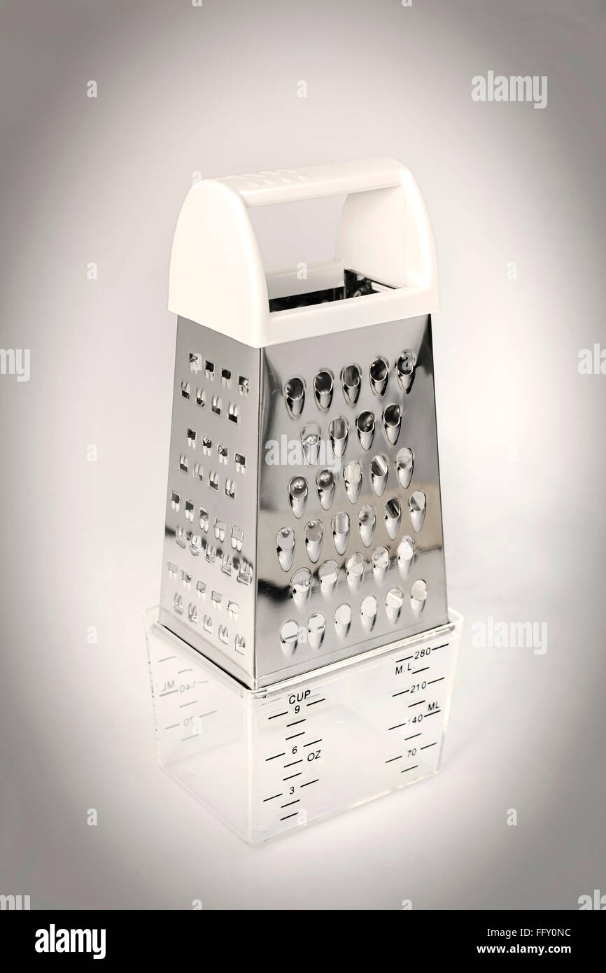 Kitchen things , four sided grater with container on white background Stock Photo