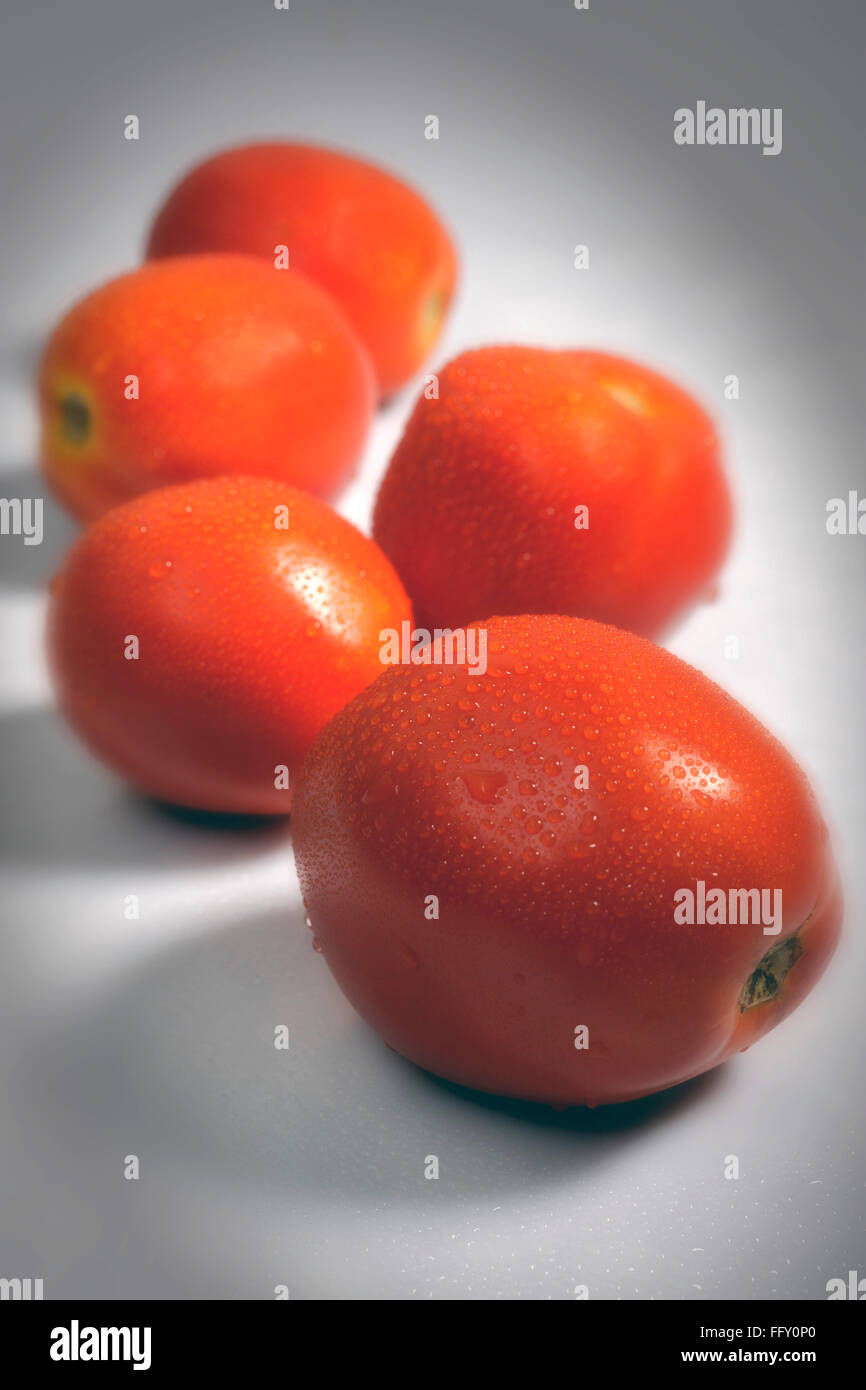 Vegetables , water drops on red tomatoes on white background Stock Photo