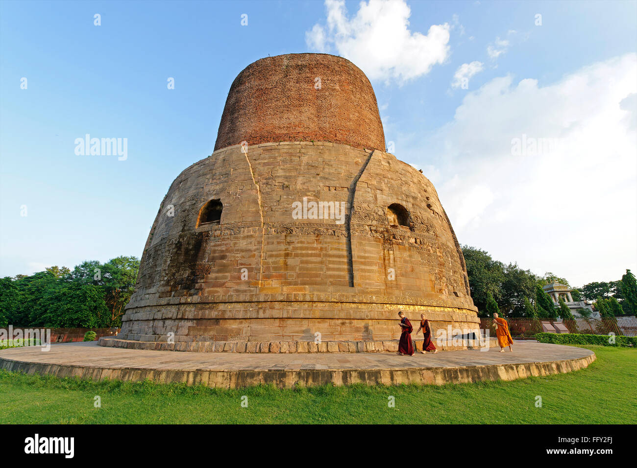 Buddhist monks at Dhamekh stupa Fifth century A.D. Sarnath near Varanasi , Uttar Pradesh , India Stock Photo