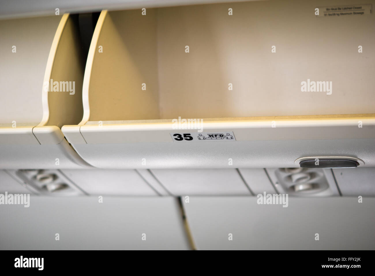 Overhead luggage compartment of airplane Stock Photo