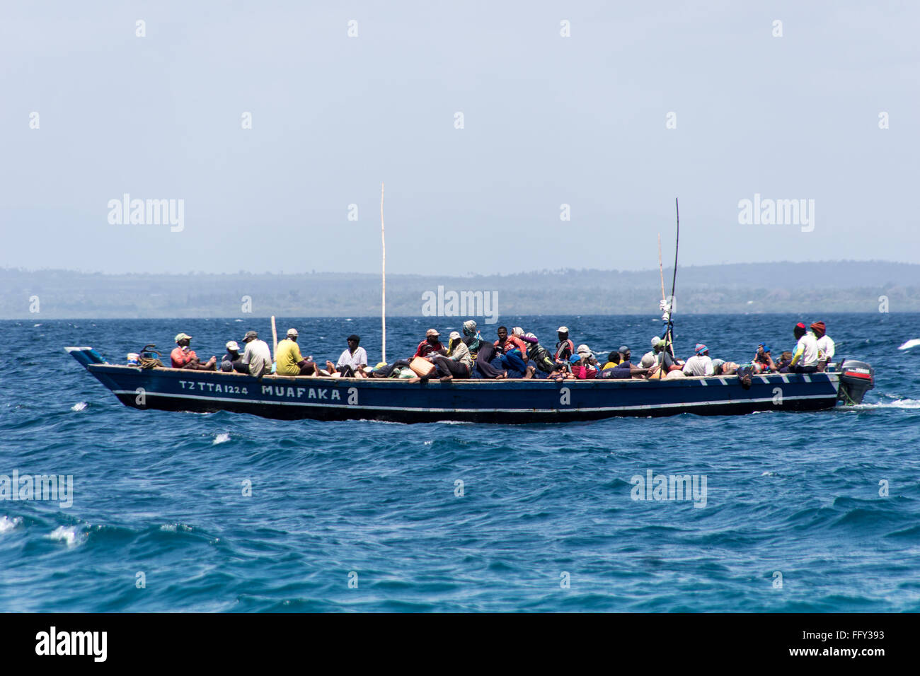A crowded local fishing boat sailing in the Indian ocean, Tanzania, Africa Stock Photo