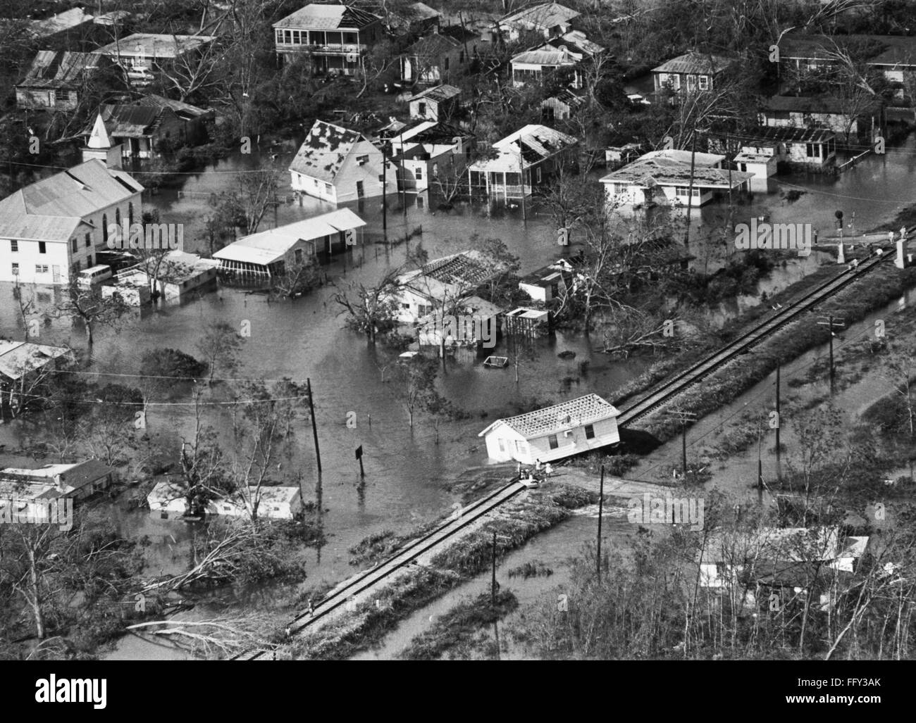 MISSISSIPPI: HURRICANE, 1969. /nAerial view of Gulfport, Mississippi, showing flooding in the aftermath of Hurricane Camille, 18 August 1969. Five people await evacuation on the railroad tracks, their home having been lifted onto the tracks by 150 mile an Stock Photo