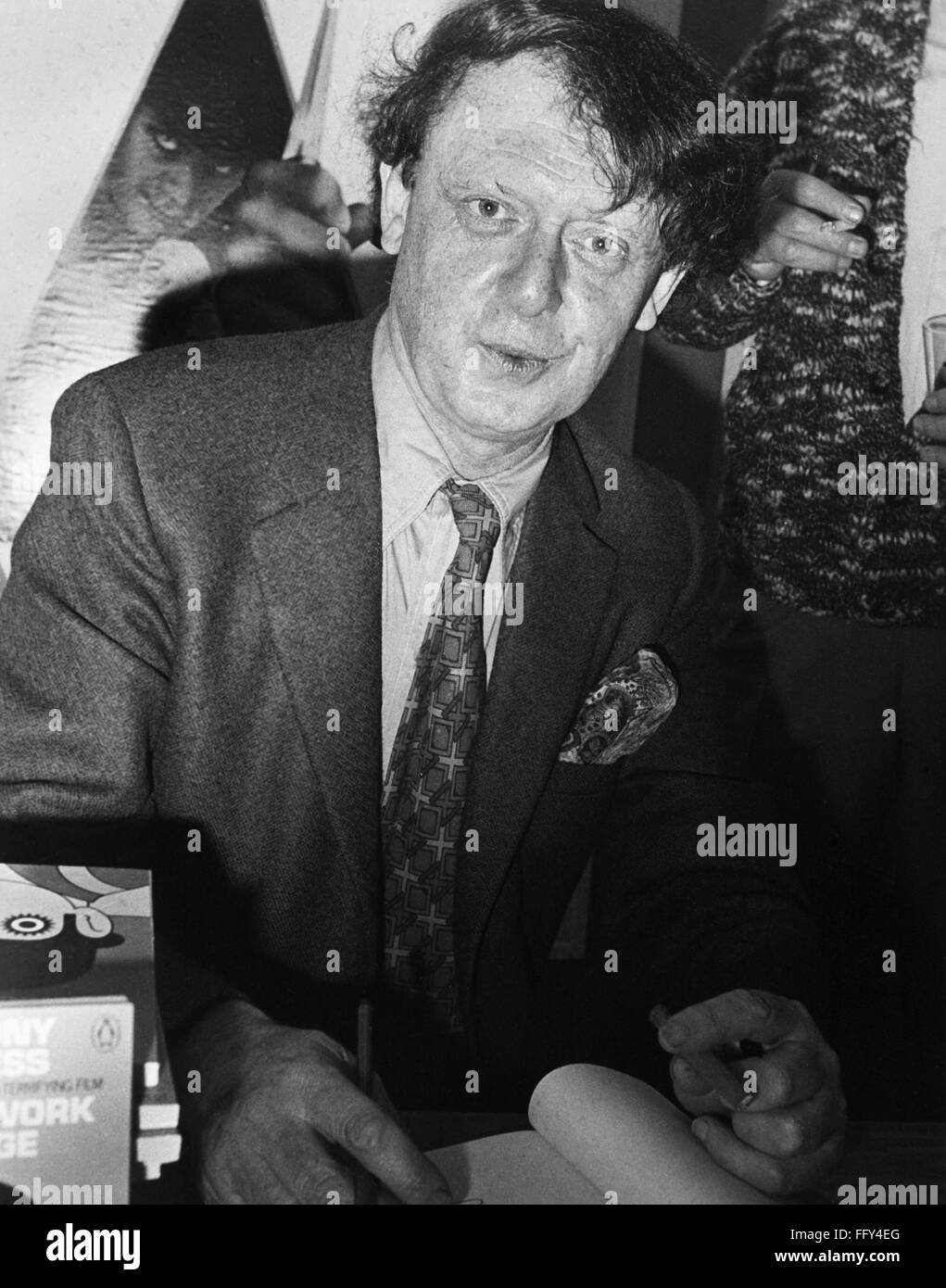 ANTHONY BURGESS (1917-1993). /nEnglish writer. Burgess signing copies of his book, 'A Clockwork Orange,' at the Cannes Film Festival where the film made by Stanley Kubrick was screened. Photograph, 16 May 1971. Stock Photo