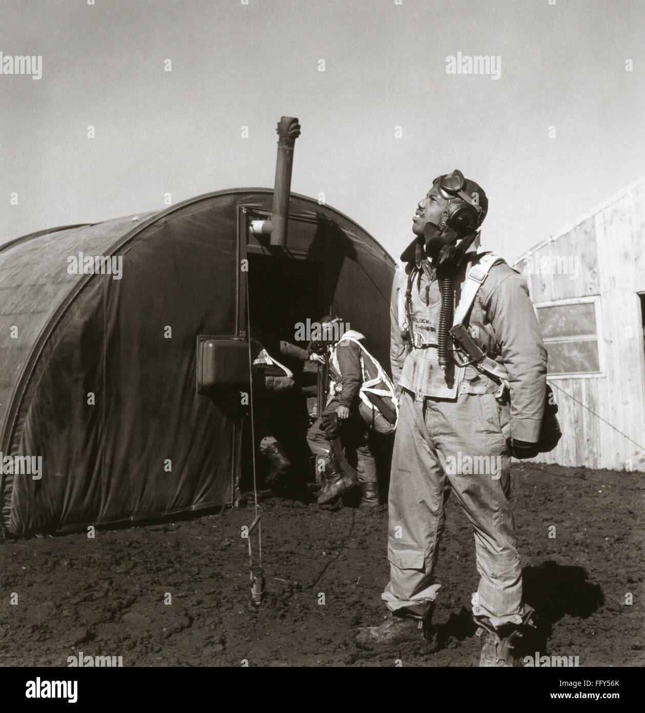 WWII: TUSKEGEE AIRMAN, 1945. /nFighter pilot Newman Golden of the Tuskegee Airmen scans the skies. Behind him is the parachute room, at Ramitelli Airfield, Italy. Photograph by Toni Frissell, March 1945. Stock Photo