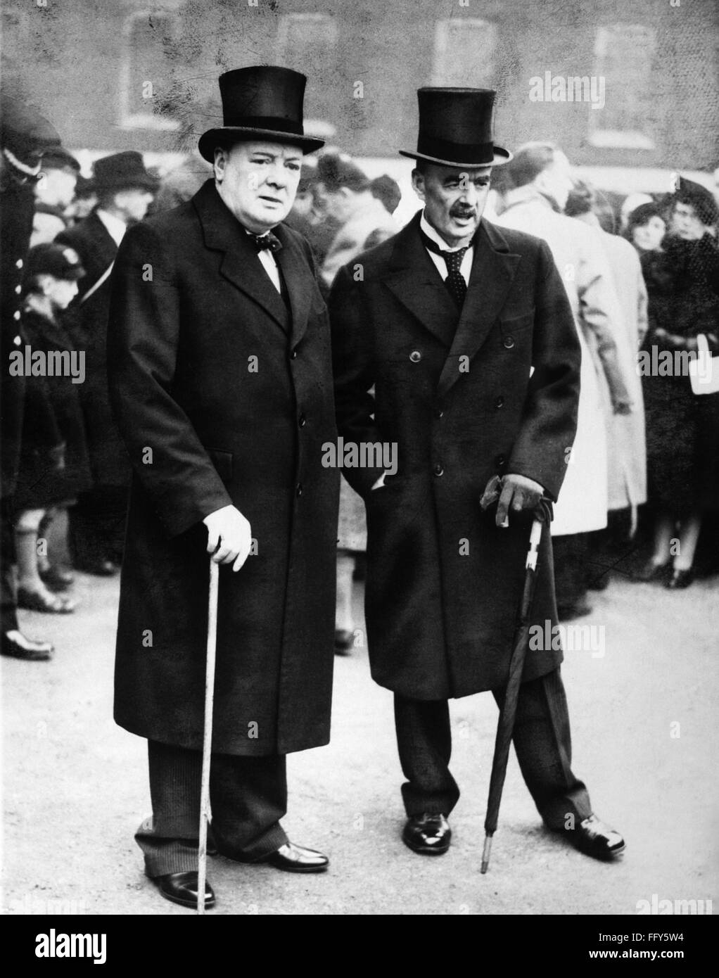 CHURCHILL & CHAMBERLAIN. /nBritish statesman Winston Churchill (left) with Prime Minister Neville Chamberlain at an outdoor ceremony, 1940. Stock Photo