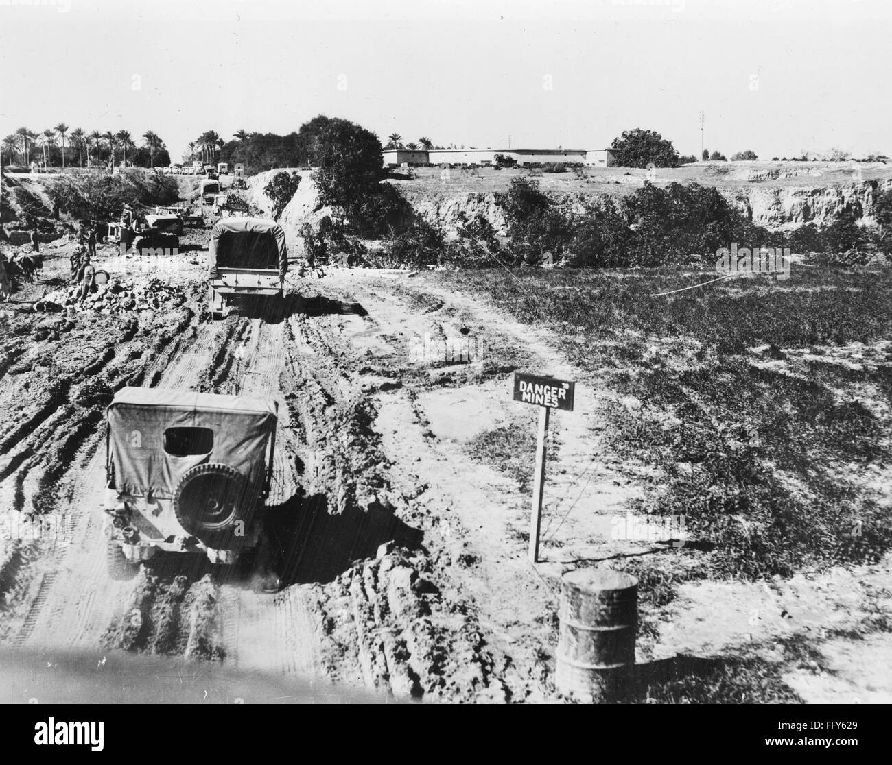 WORLD WAR II: LIBYA. /nU.S. Army Jeeps driving past an area containing ...