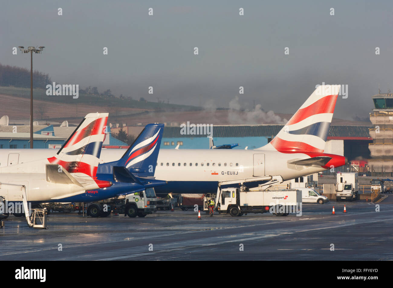 Tails of airliners lined up on the apron at Aberdeen airport - Scotland, UK. Stock Photo