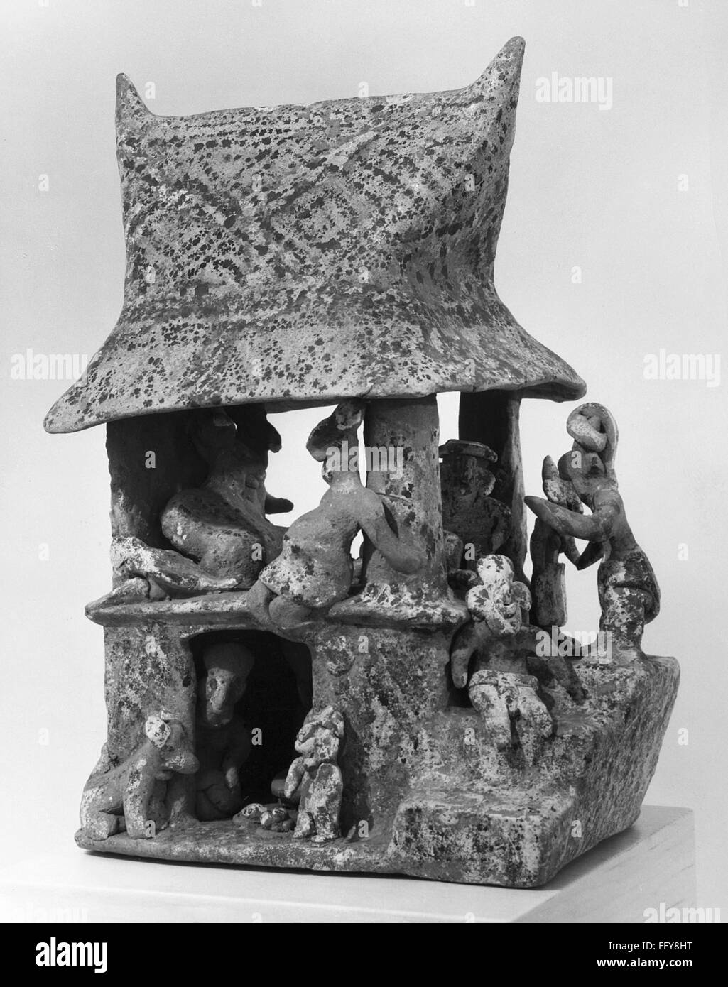 MEXICO NAYARIT HOUSE./nCeramic sculpture of people at a house. By the