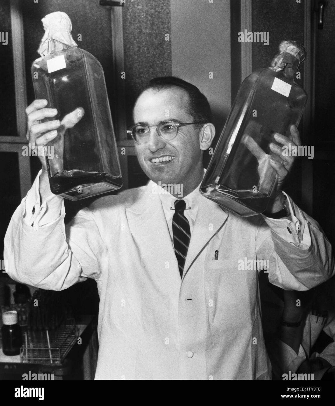 JONAS EDWARD SALK /n(1914-1995). American microbiologist. Salk holding ...