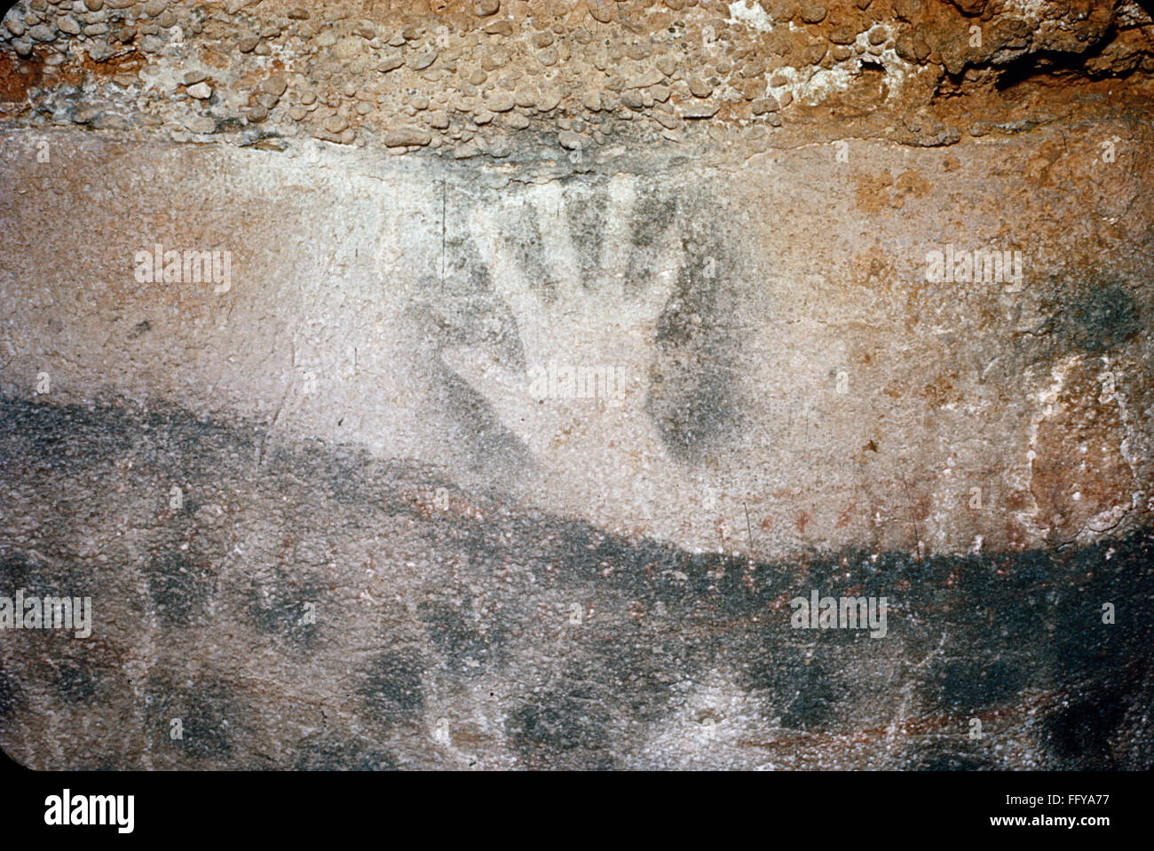 CAVE ART PECH MERLE. /nHuman handprint and painted dots on a wall of