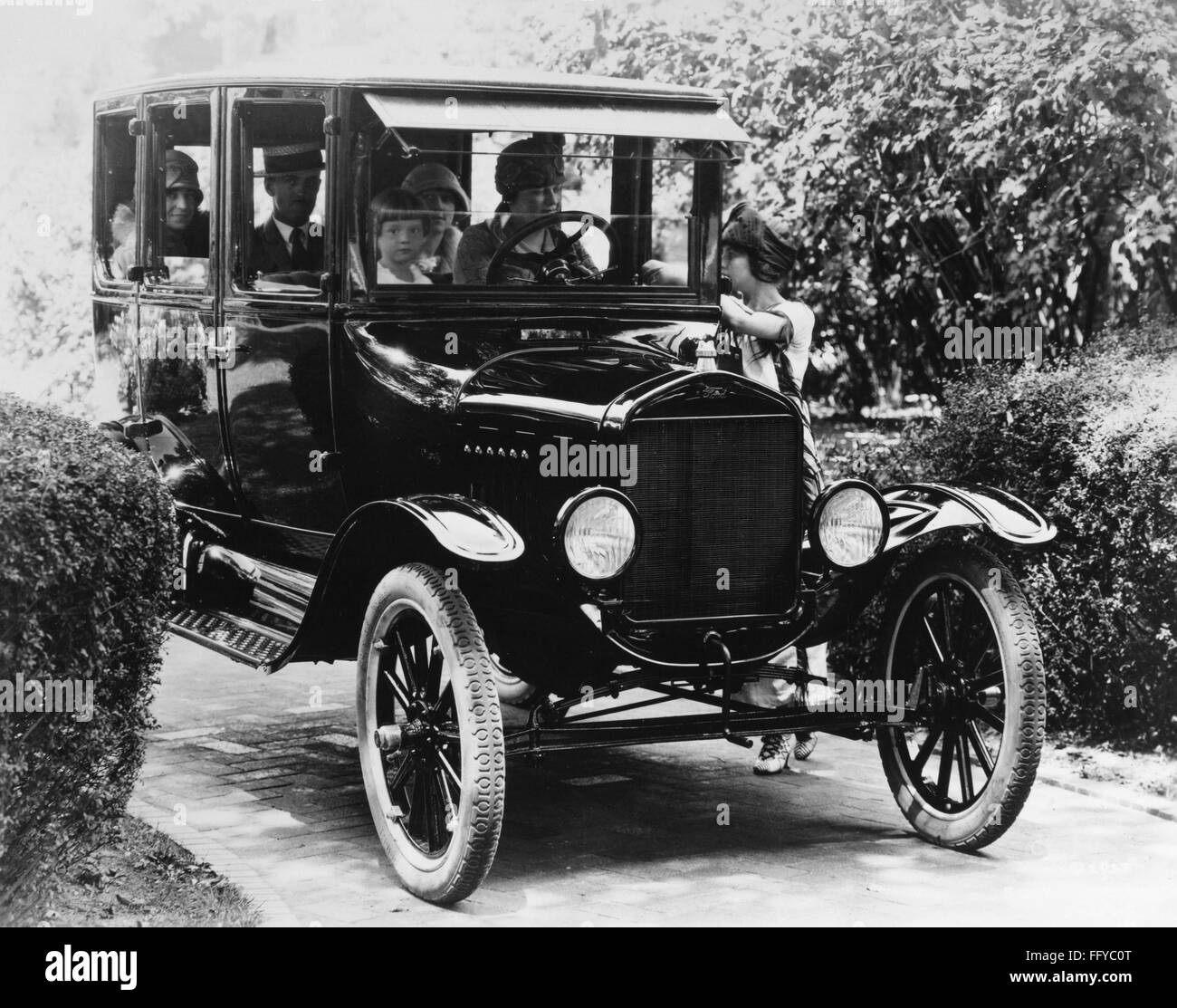FORD SEDAN, 1923. /nA family driving a Ford sedan. Photograph, 1923