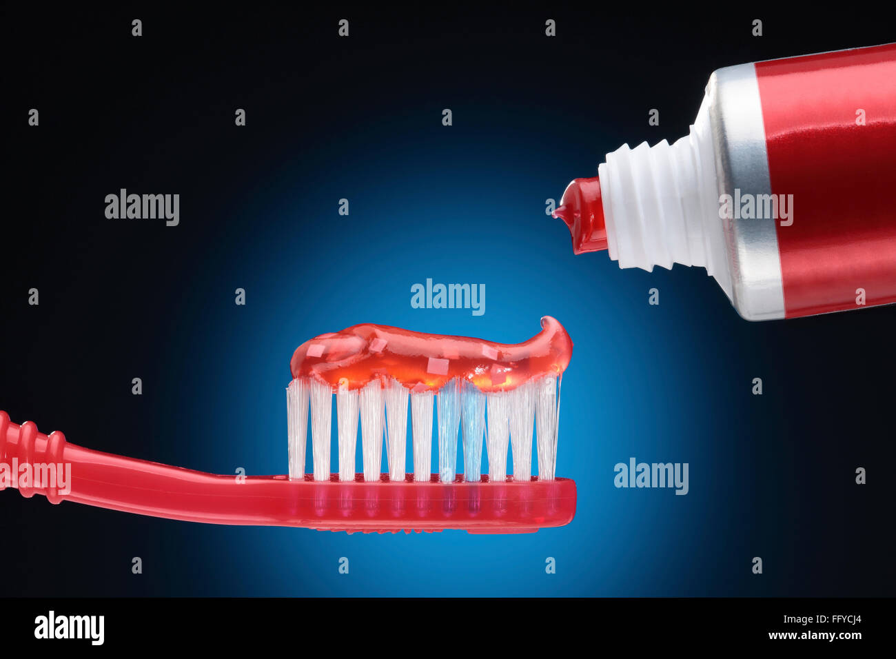 Red tooth paste or gel from tube on red brush Stock Photo Alamy