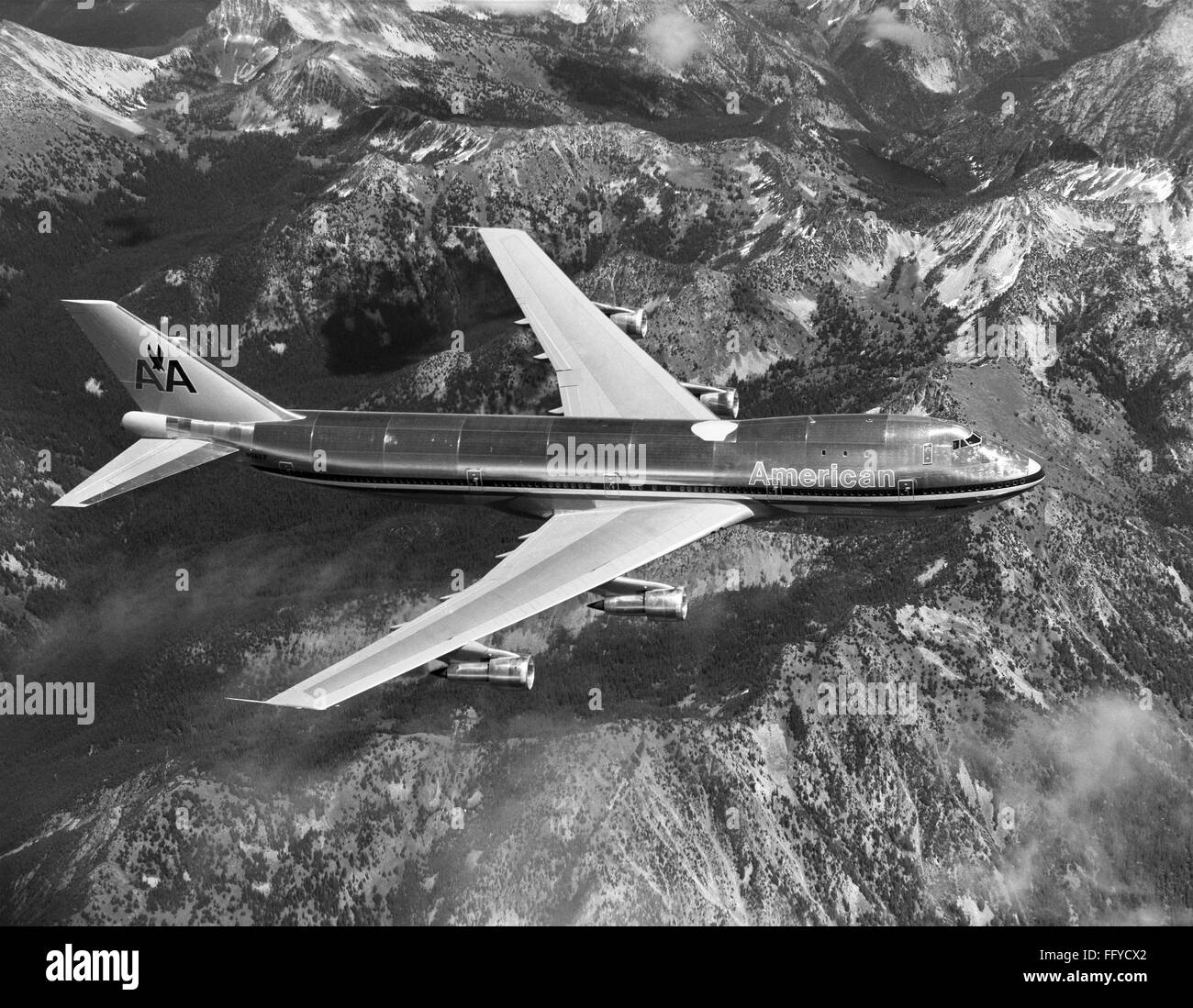 AMERICAN AIRLINES PLANE. /nA Boeing 747 passenger plane operated by American  Airlines in flight over a mountain range. Photograph, late 20th century  Stock Photo - Alamy, image size:1300x1099