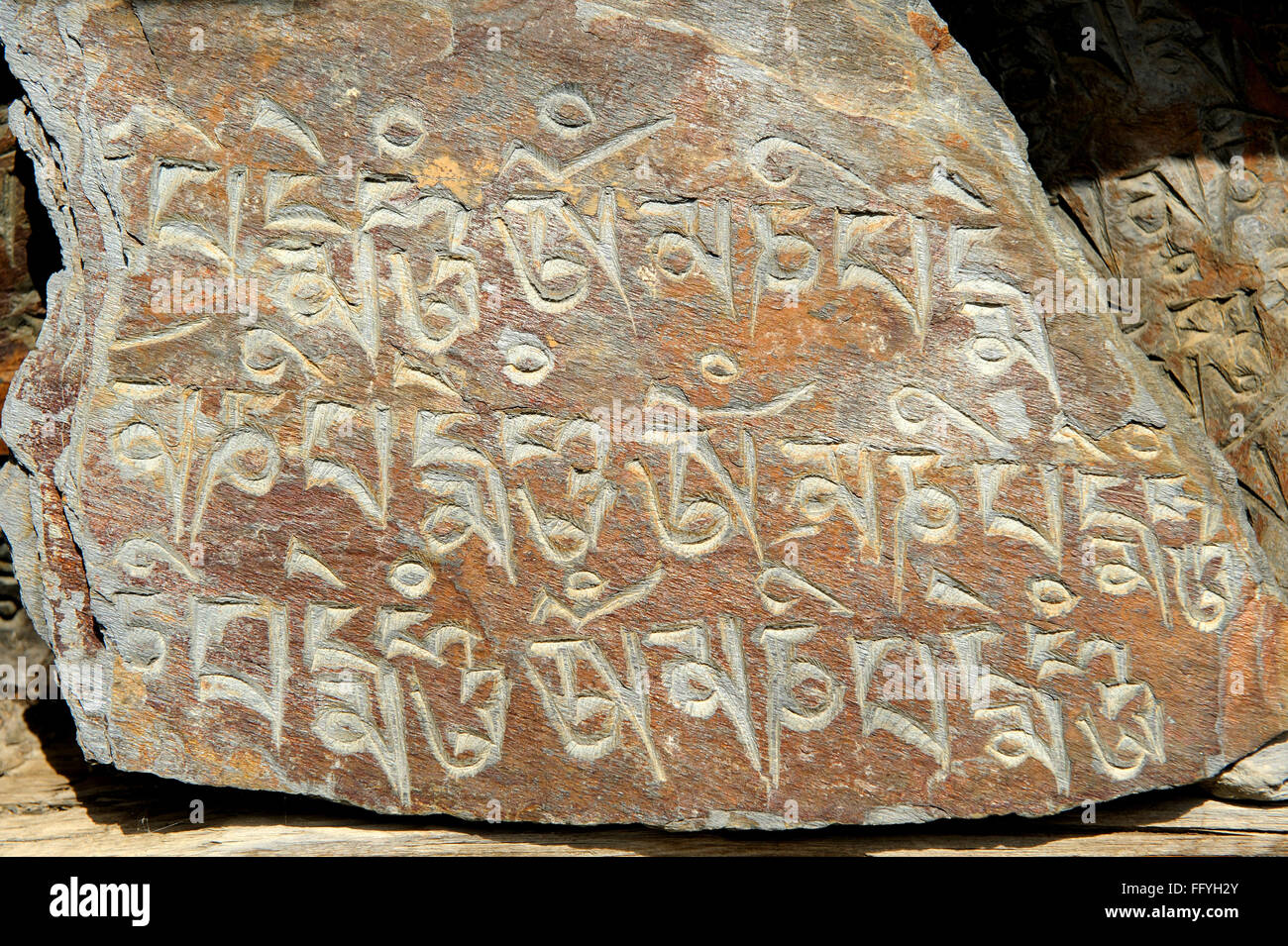Holy stone engraved buddhist mantra ; Dhukur ; Pokhari ; Pisang ; Nepal Stock Photo