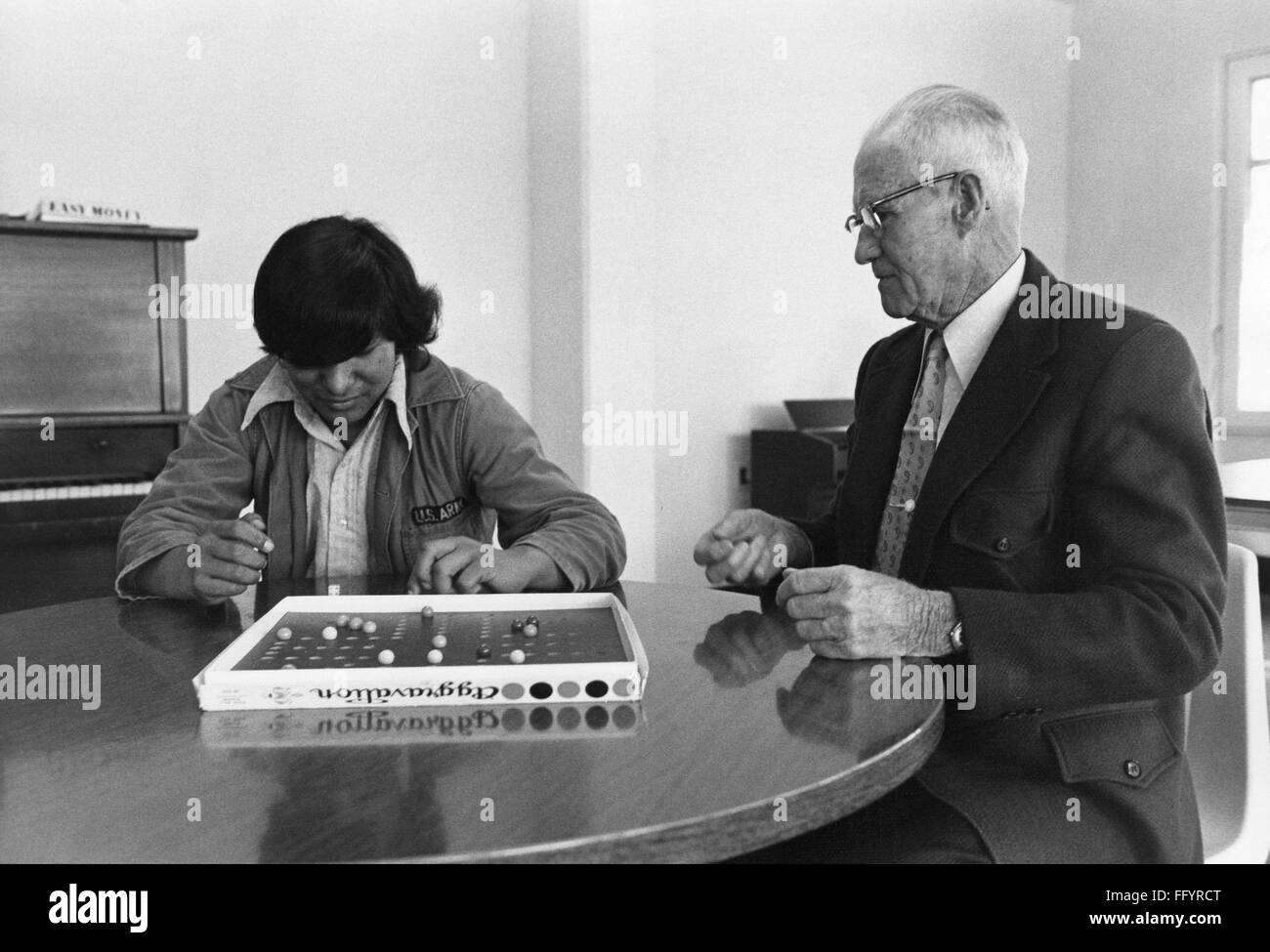 MISSISSIPPI BOARD GAME, 1973. /nA Native American boy playing the