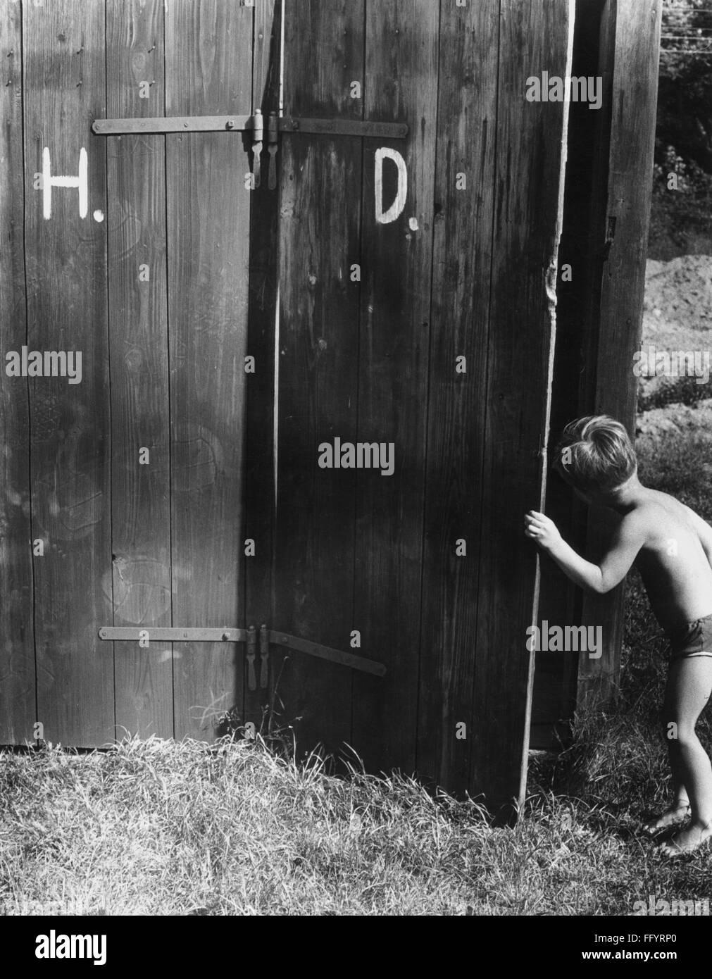 architecture, toilet, loo made wood, boy looking curiously into ladies toilet, 1960s, Additional-Rights-Clearences-Not Available Stock Photo