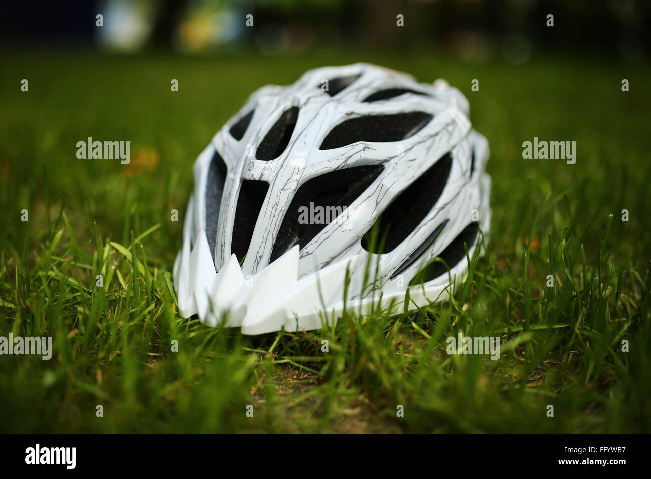 Bicycle helmet on grass Stock Photo - Alamy