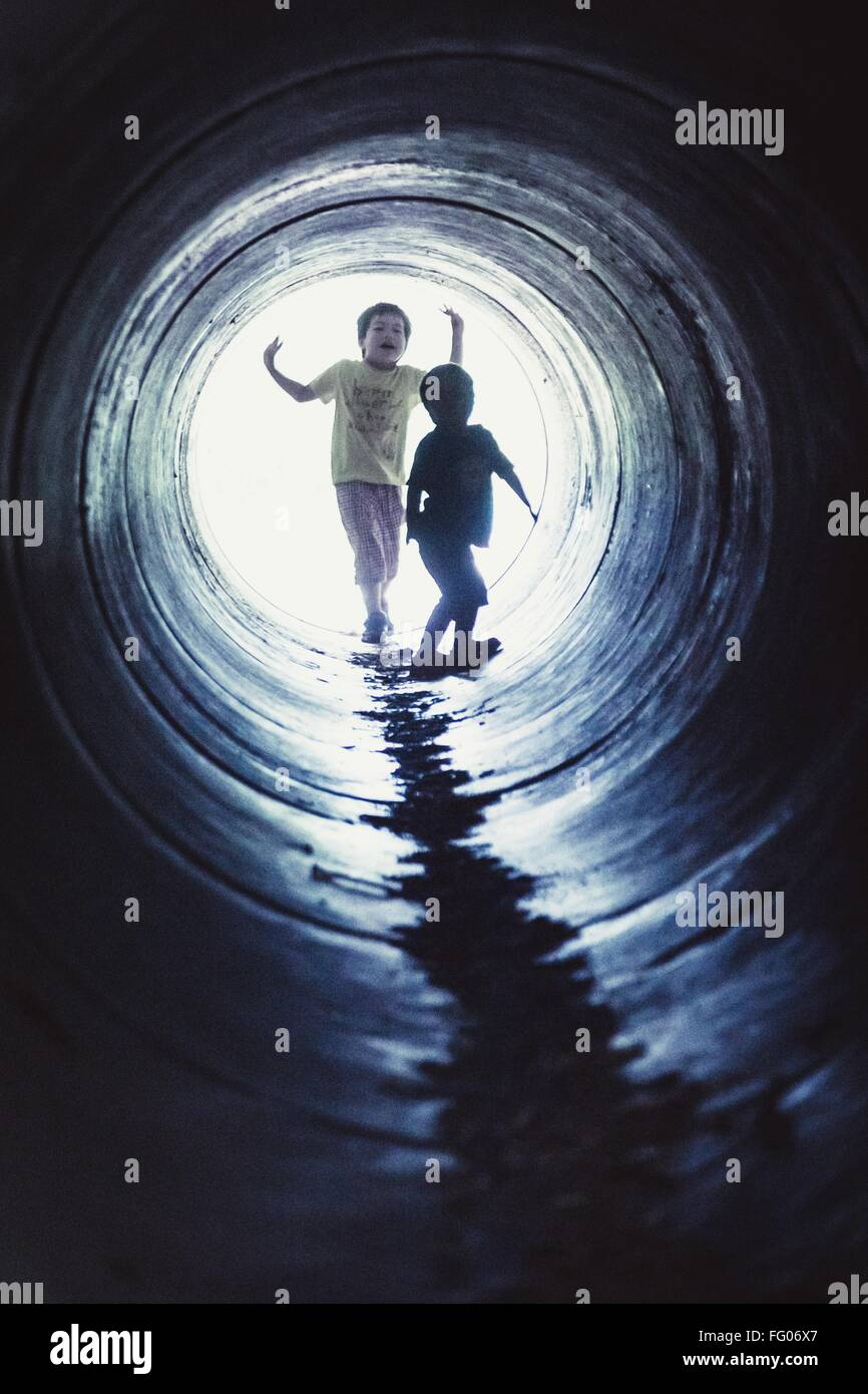 Kids Playing In Pipe Stock Photo