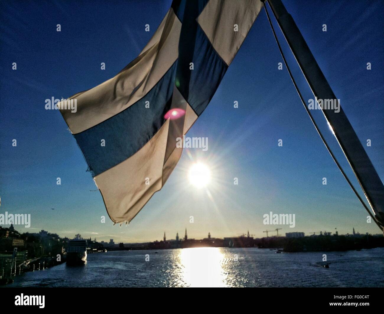 Finnish Flag Against Bright Sky Stock Photo