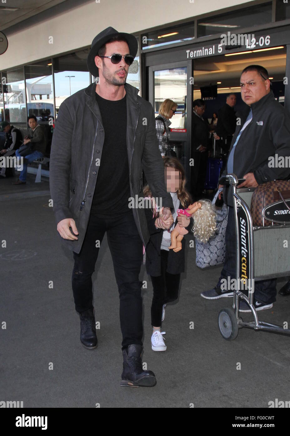 William Levy arrives at Los Angeles International Airport (LAX) with Elizabeth Gutierrez and their children, Christopher and Kailey  Featuring: William Levy, Kailey Alexandra Levy Where: Los Angeles, California, United States When: 08 Jan 2016 Stock Photo