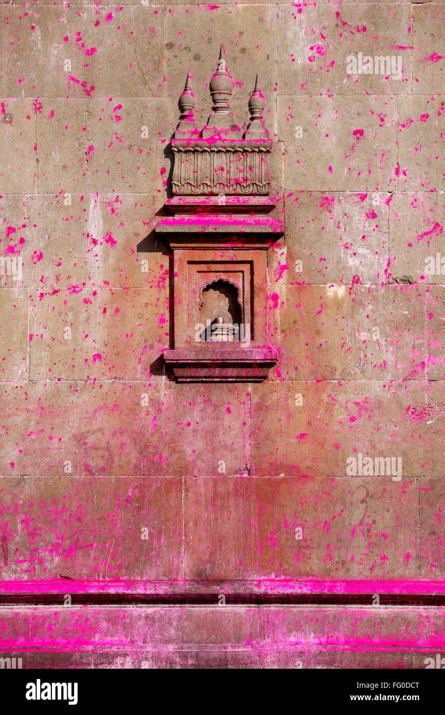 Art work on wall of Jotiba temple immersed in gulal bright shades of pink powder Kolhapur Village Wadi Ratnagiri Maharashtra Stock Photo