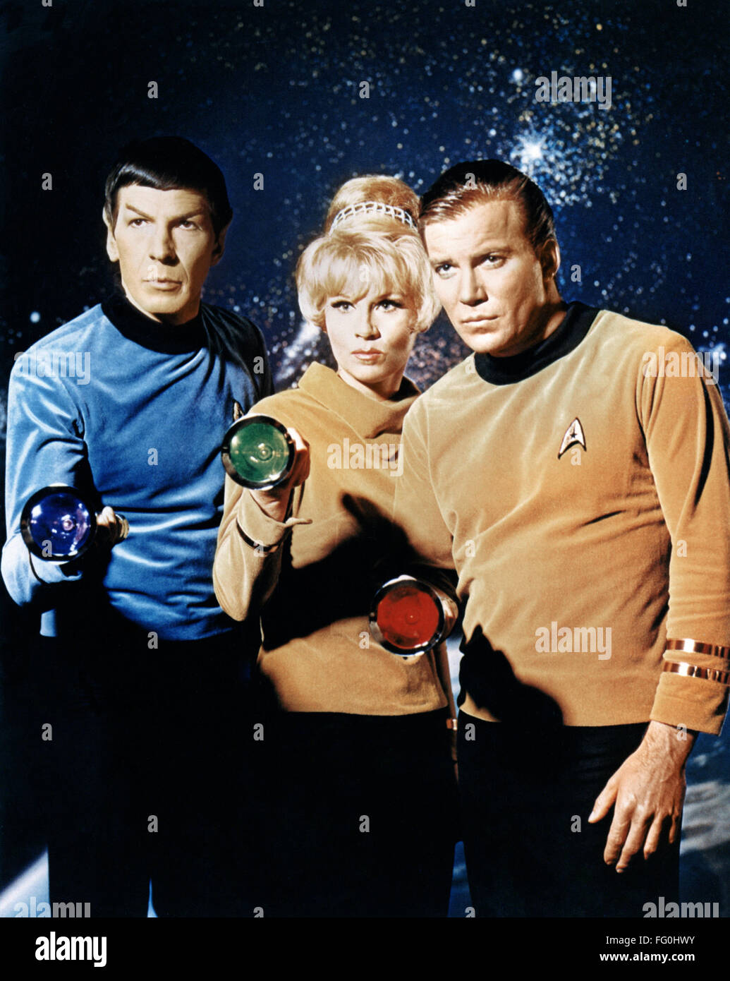STAR TREK, 1966. /nLeft to right: Leonard Nimoy as Mr. Spock, Grace Lee Whitney as Yeoman Janice Rand, and William Shatner as Captain James Kirk, holding colored flashlights in a publicity still for the American television series 'Star Trek,' 1966. Stock Photo