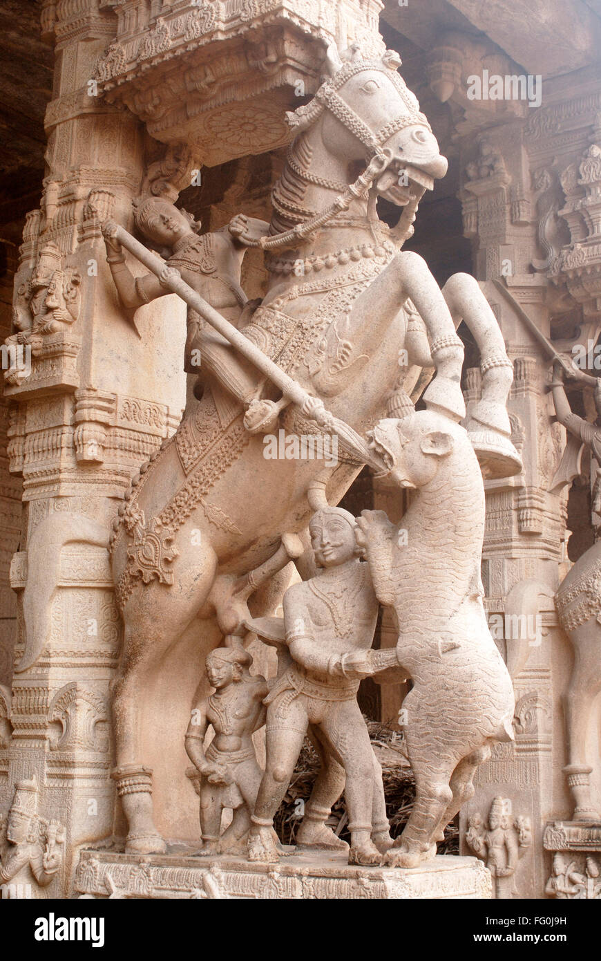 Carved statue warrior horse fighting wild animal pillar Sesharayar Mandapam Ranganathswami temple Srirangam Trichy Tamil Nadu Stock Photo