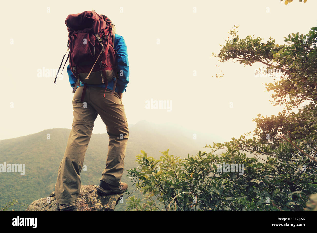 young woman backpacker hiking at mountain peak Stock Photo - Alamy