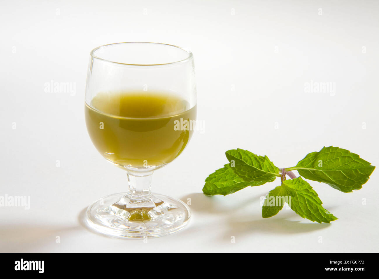 Green spices mint juice against white background , pudina ka rus , India Stock Photo