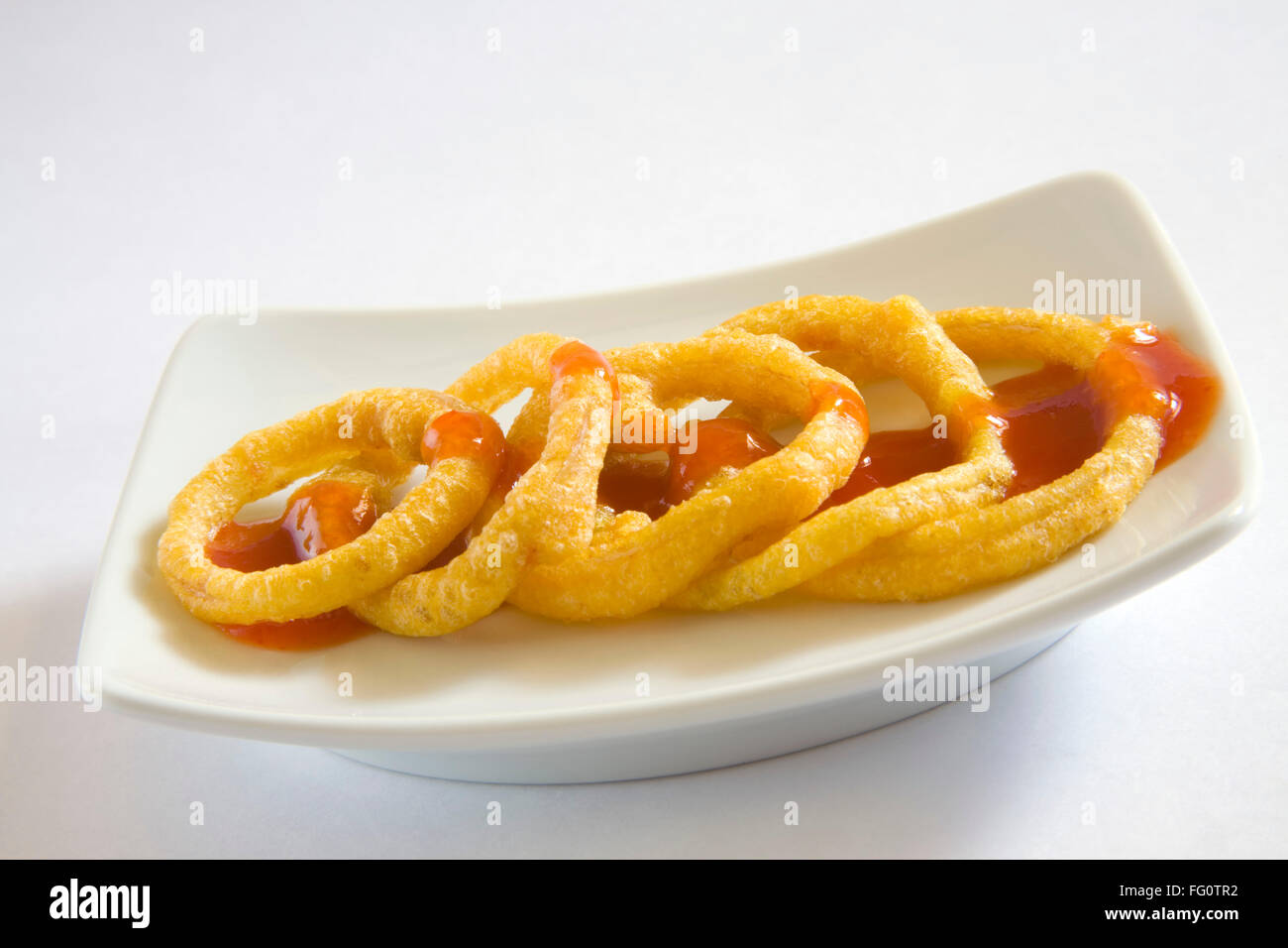Kandy Bhaji crispy onion fritters rings served with tomato ketchup dish