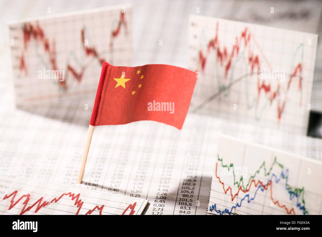 Chinese flag with rate tables and graphs for economic development. Stock Photo