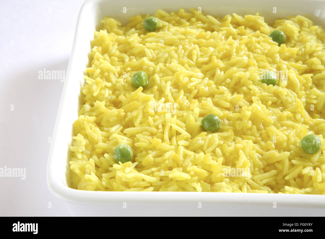 Indian cuisine khichdi garnish green peas served in deep plate on white