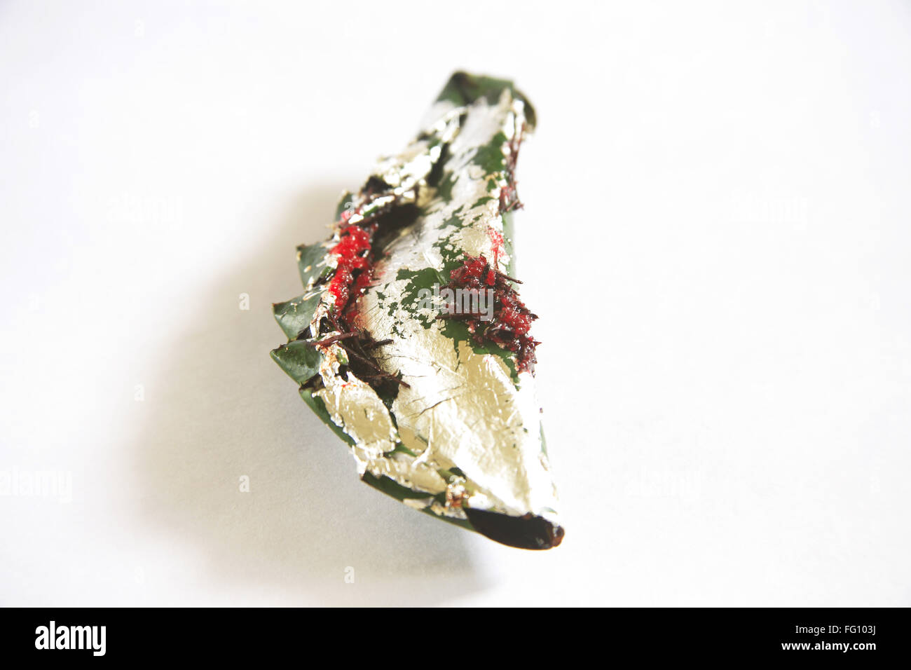 Gilouri pan prepared and folded in betel leaves on white background Stock Photo