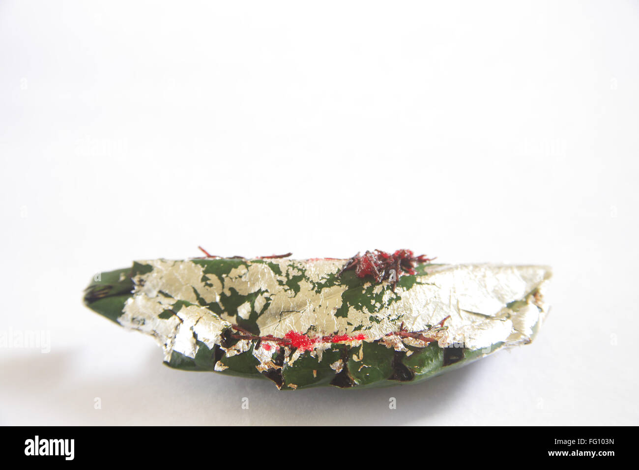 Gilouri pan prepared and folded in betel leaves on white background Stock Photo