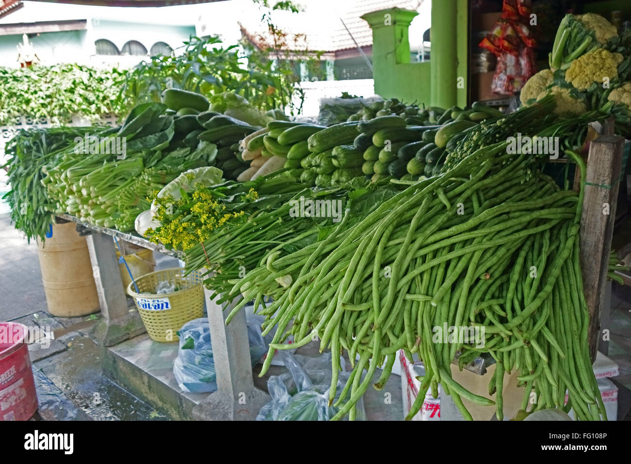 Yardlong beans, bitter melon, cauliflower and other vegetables on a vegetable stall in Bangkok, Thailand Stock Photo