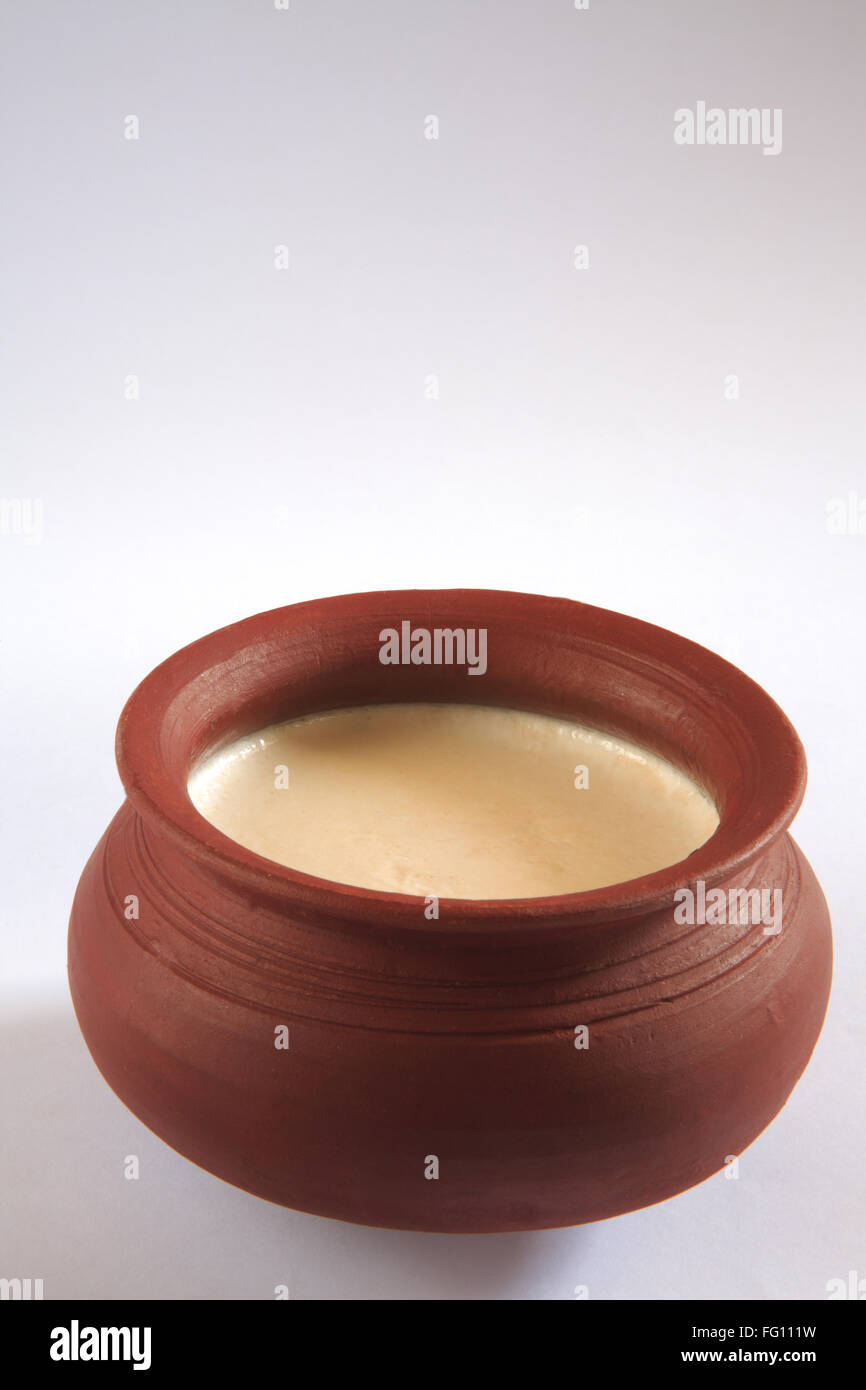 Indian sweet , mishti doi bengali mithai in earthen pot on white