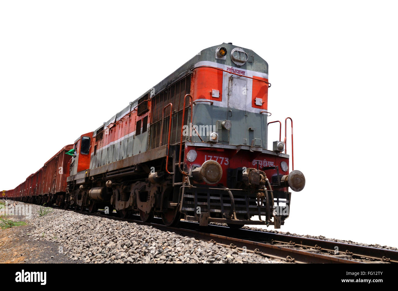 Goods train engine on railway track against white background of sky India Stock Photo