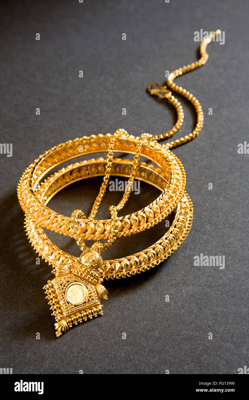 Gold necklace with locket and kangan bangle India Stock Photo