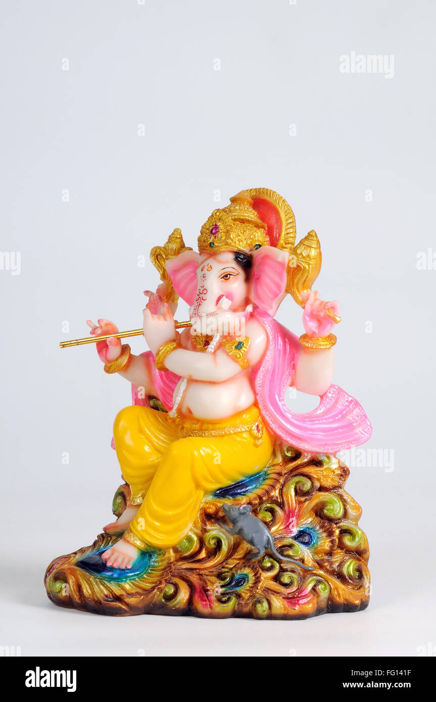 Statue of lord ganesh playing flute ; India Stock Photo