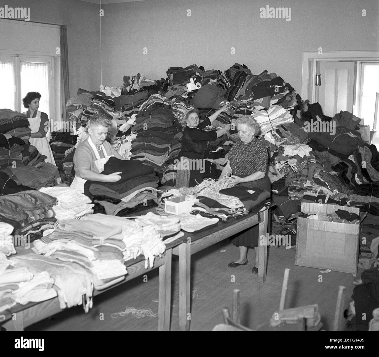 German Red Cross workers in Frankfurt in November 1956 with donated blankets for hungarian refugees. Due to the put down of the Hungarian Uprising in 1956 by Soviet forces around 200.000 people fled the county towards the West. Stock Photo