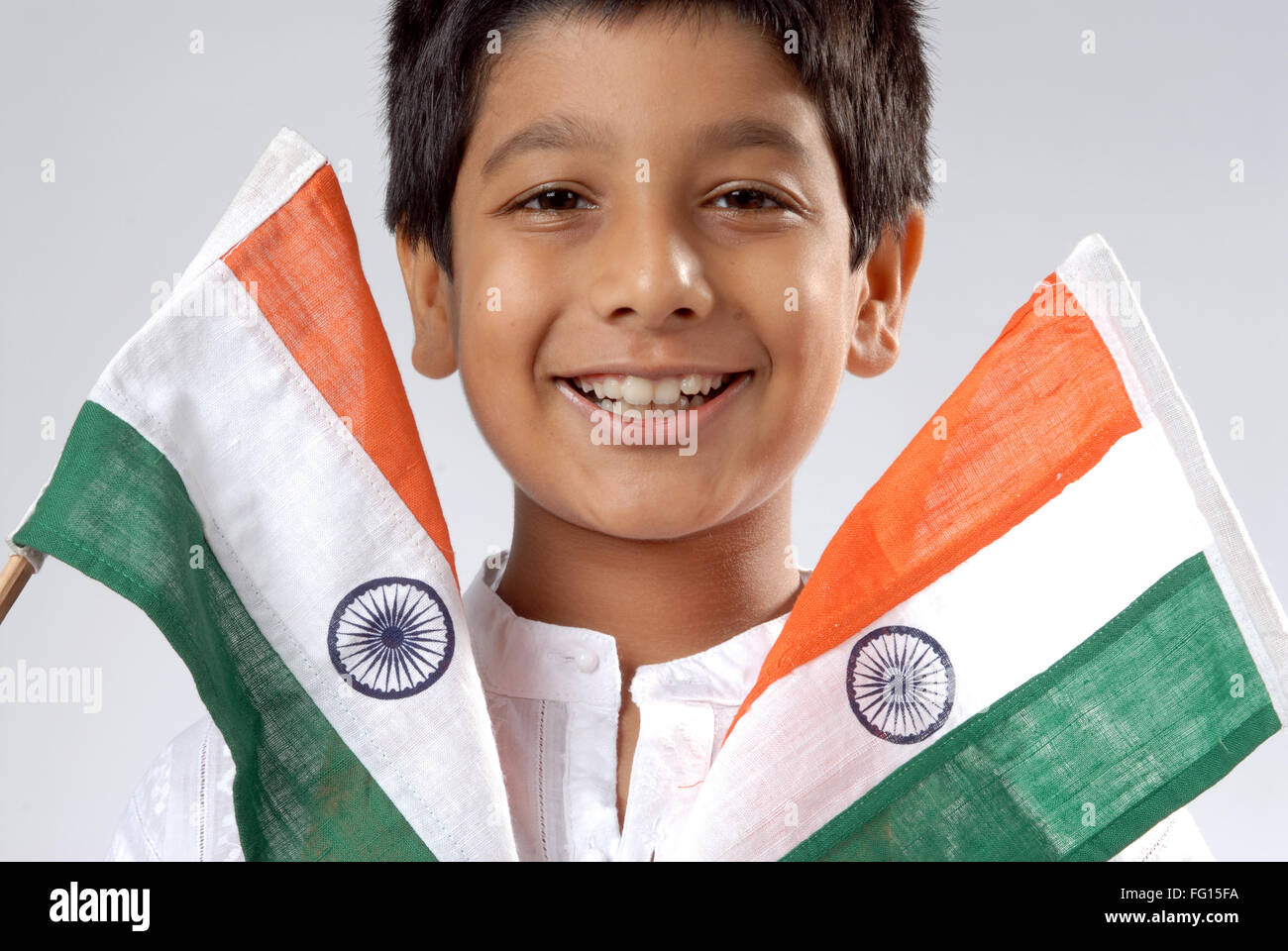 South Asian Indian boy smiling with holding two flag of India MR152