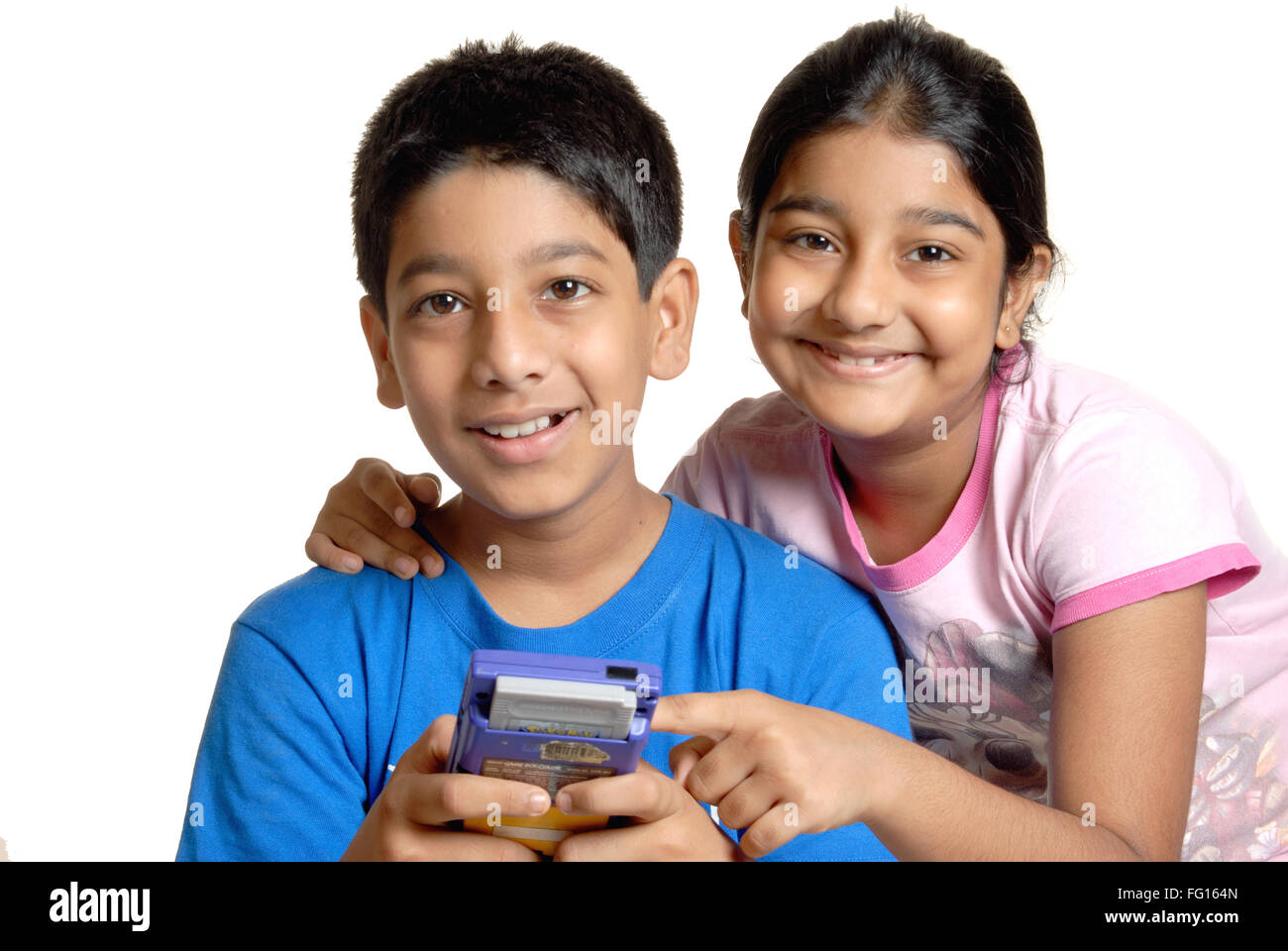 Young boy playing with digital game and girl looking at camera MR#152 Stock  Photo - Alamy