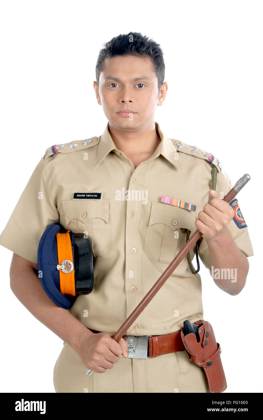 Police inspector in uniform with cap and revolver and stick in hand on white background MR#782W Stock Photo