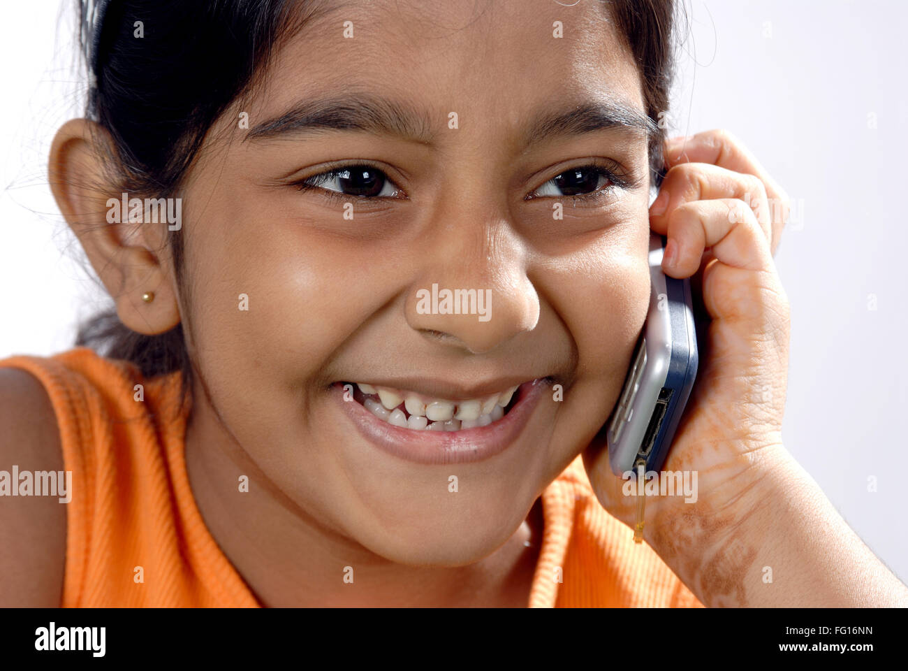 South Asian Indian eight years old girl listening good news on cell