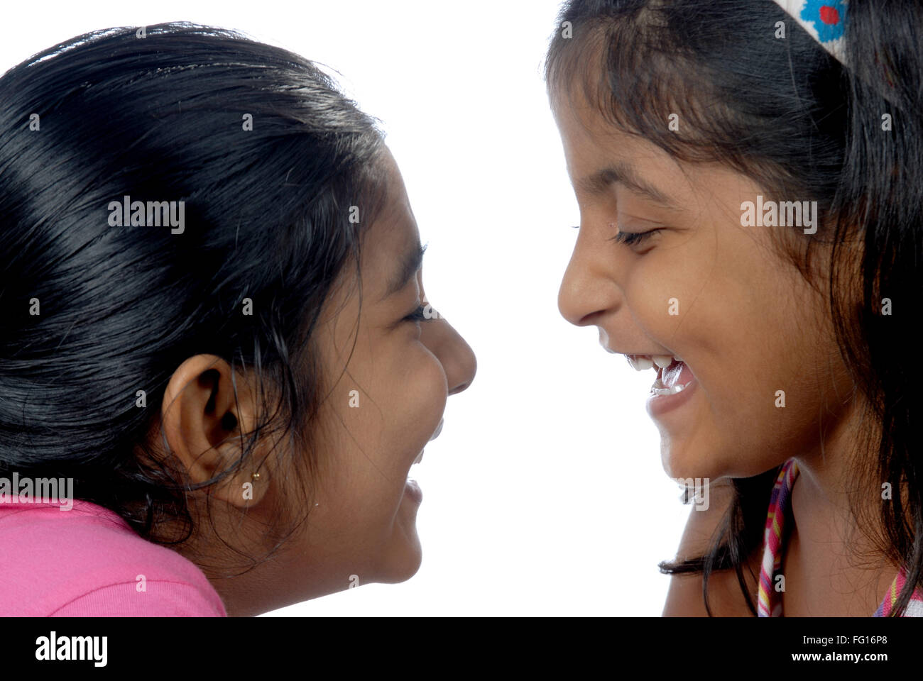 South Asian Indian girls rubbing nose to nose MR152,364 Stock Photo