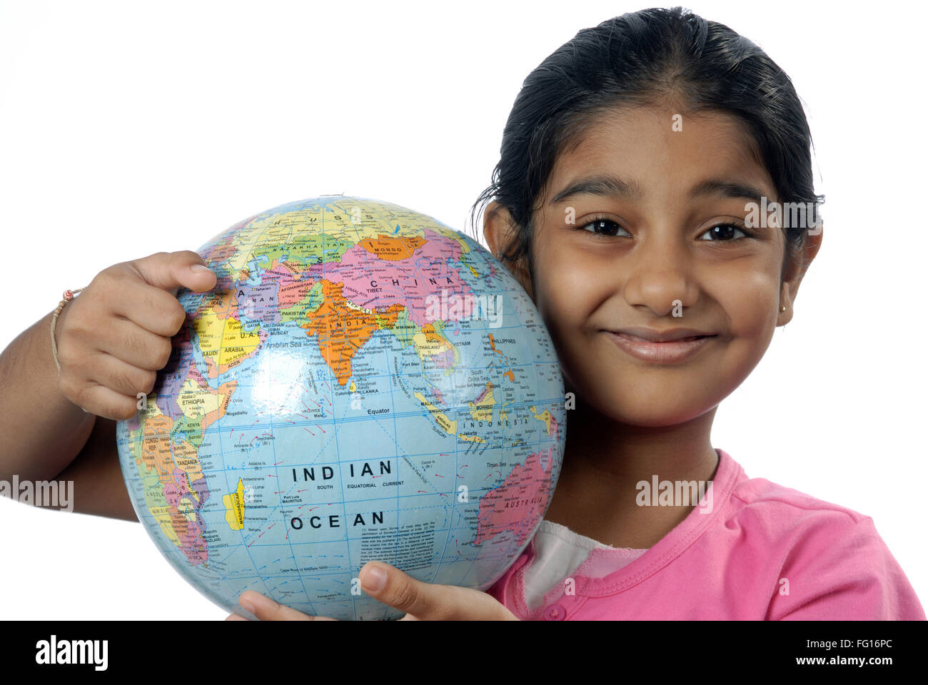 South Asian Indian six year old girl holding globe on shoulder MR#152 Stock Photo