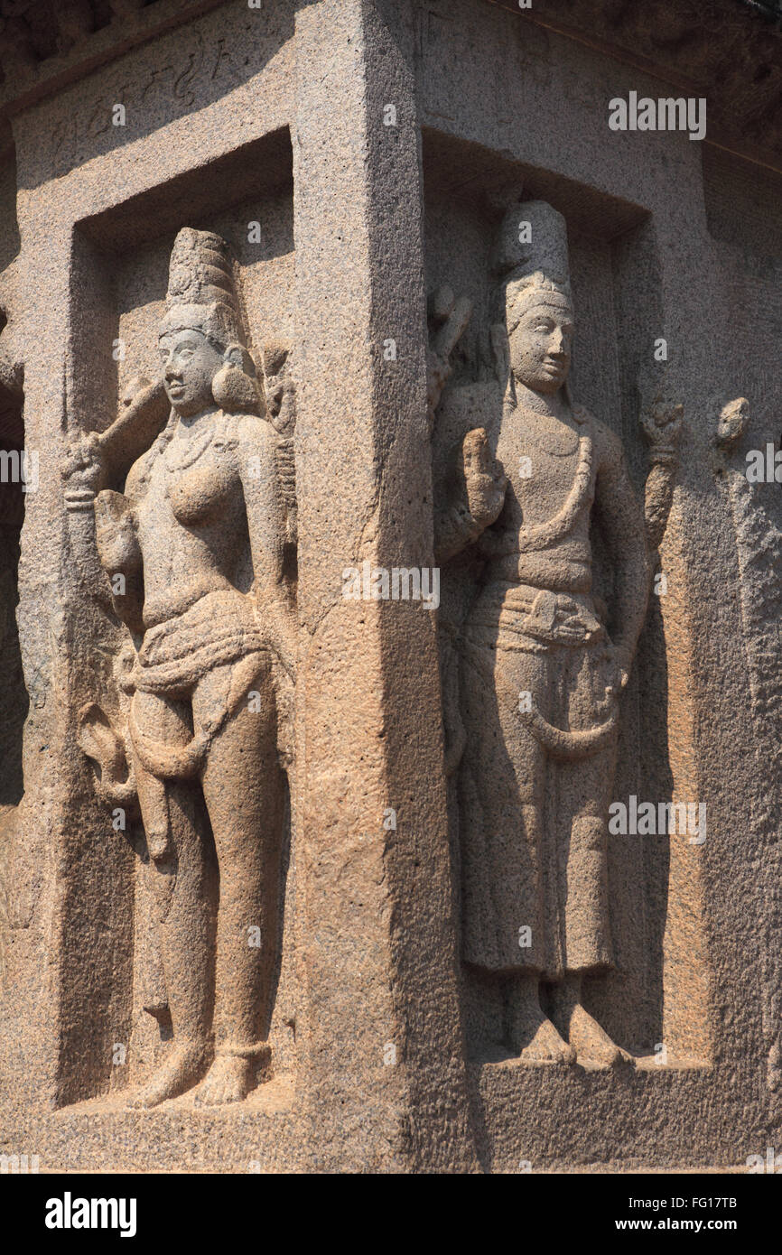 On left Ardhanariswara God Shiva on right God Harihara monolith rock carving temples Mahabalipuram Chengalpattu Tamil Nadu Stock Photo