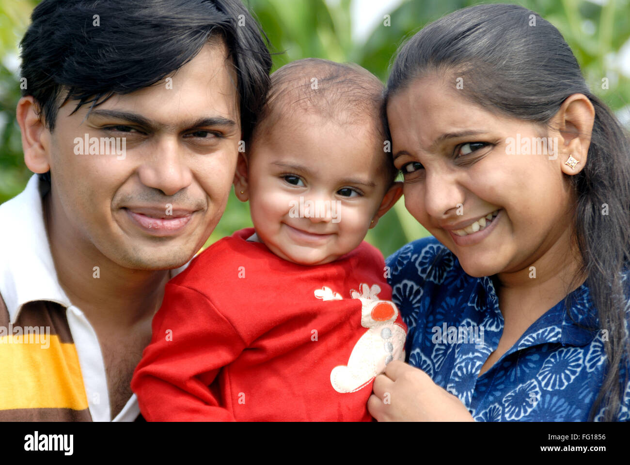 South Asian Indian child with his parents , India MR#152,364 Stock Photo